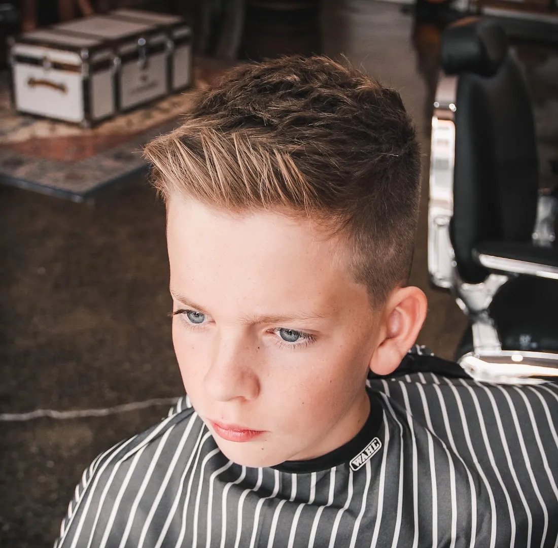A child's tidy haircut finished at Amunra Barbershop.