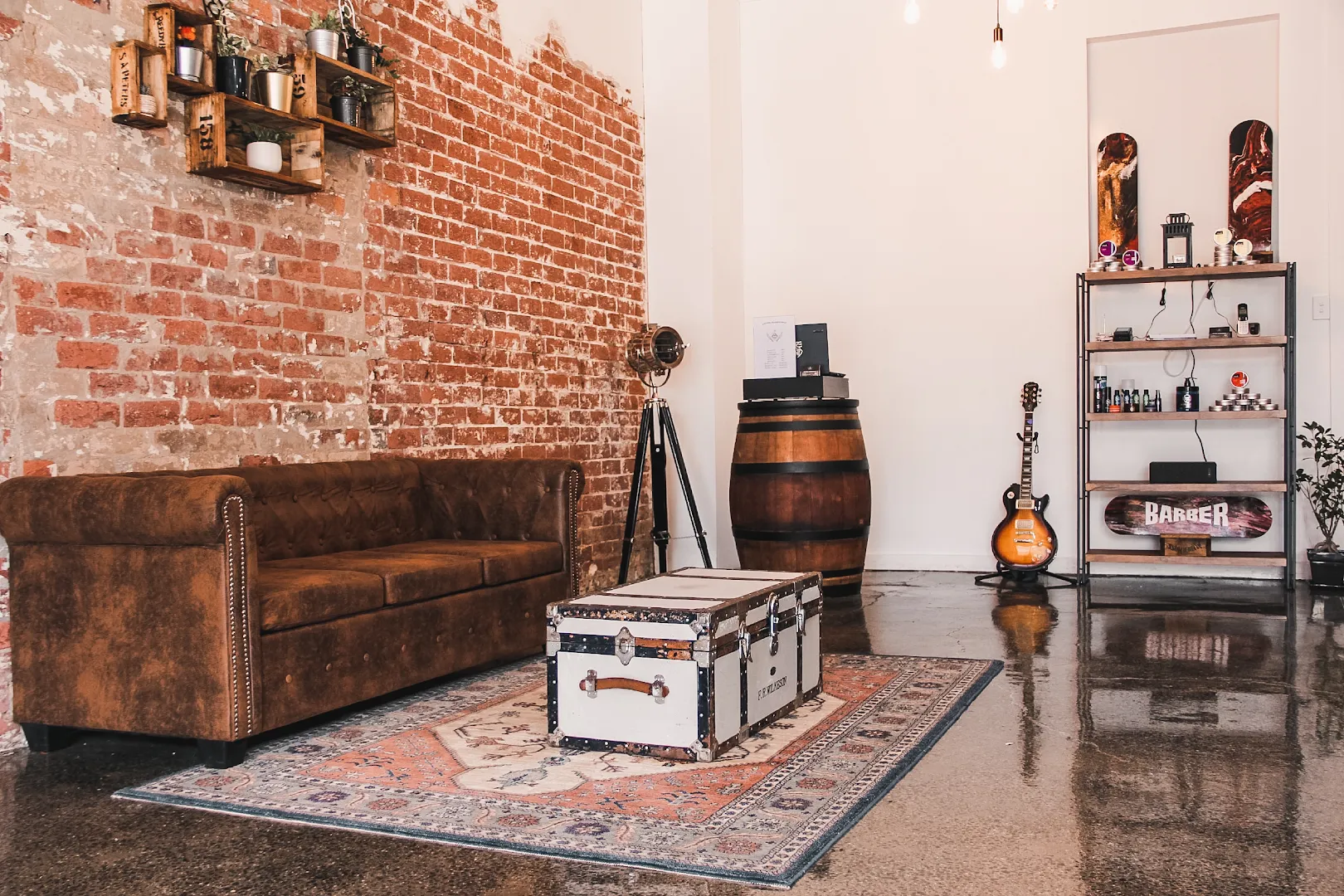 The brown leather Chesterfield and vintage steamer trunk used as a coffee table.