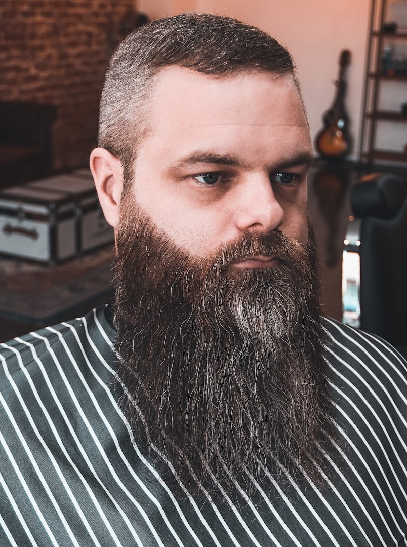 A skin fade with a hard side part, finished at Amunra Barbershop